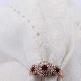 3 Red Round Rubies Halo Diamond Ring set in Rose Gold | McLean & Co Jewellers Sunshine Coast