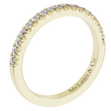 A yellow gold diamond wedding stacker band with multiple stones set around the circumference.