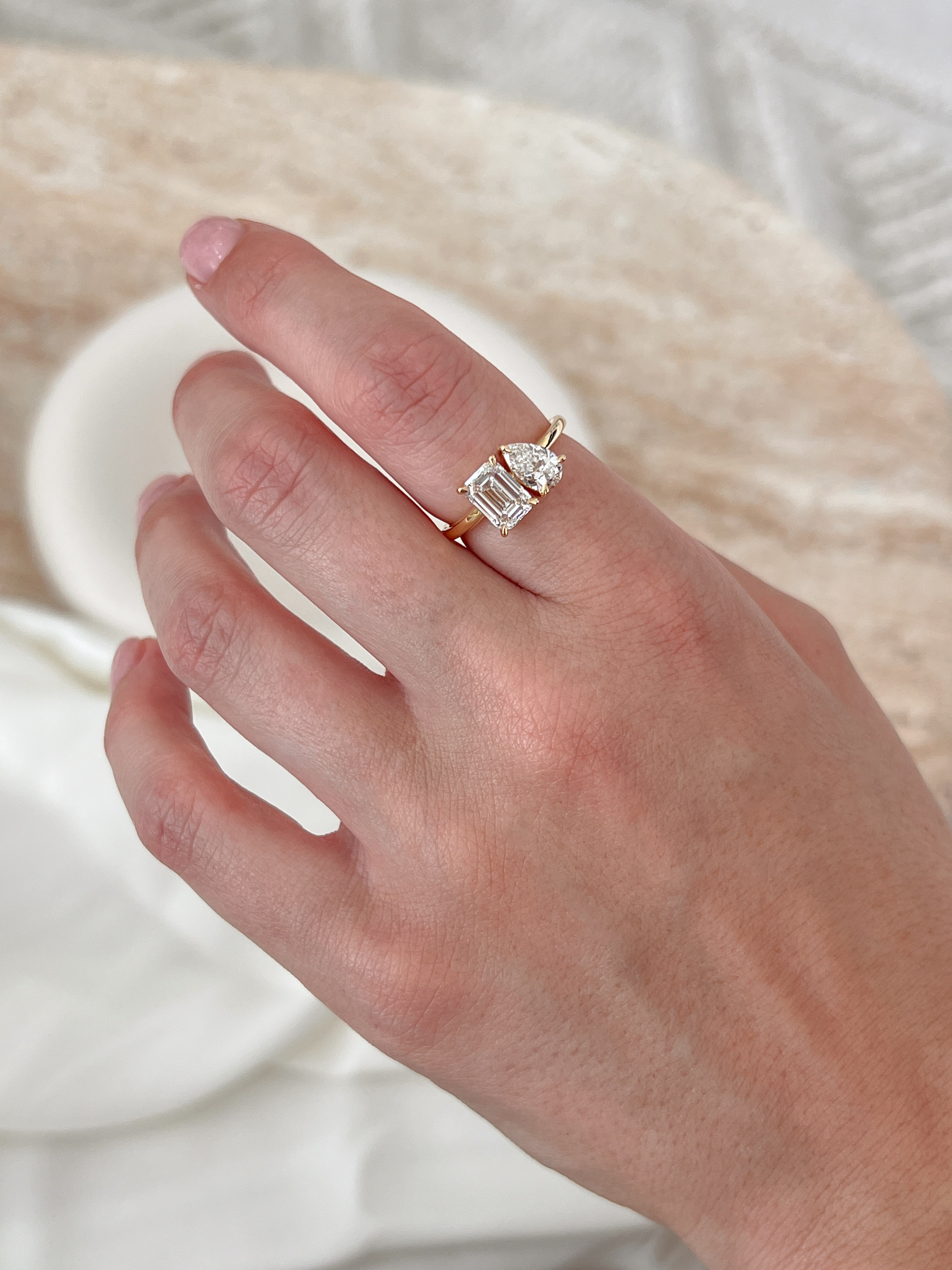 toi et moi engagement ring set in yellow gold on hand