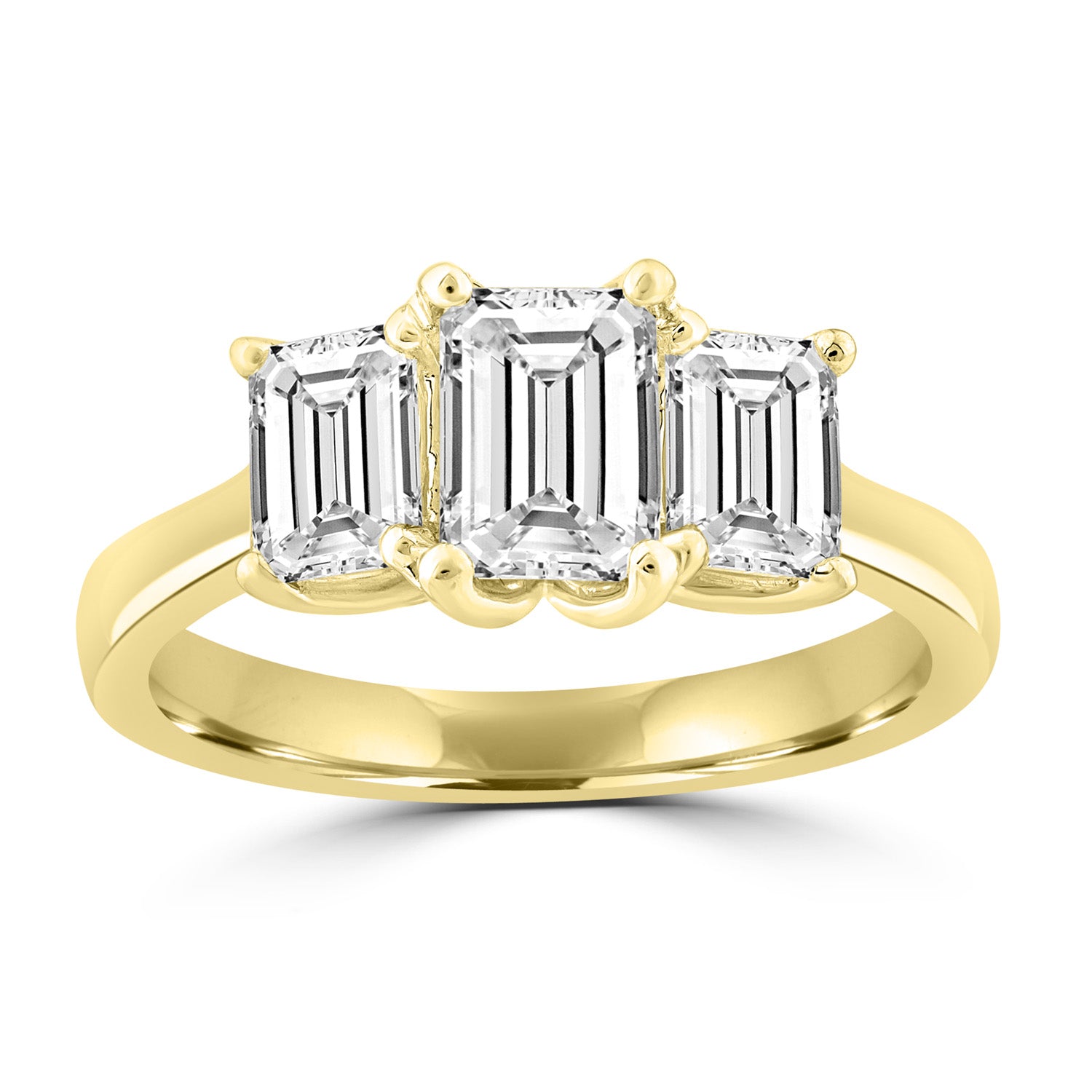 3 stone emerald cut trilogy ring set in yellow gold