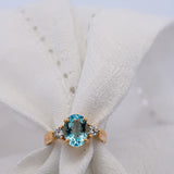 Blue Aquamarine and Diamond Ring Set in yellow gold on white background