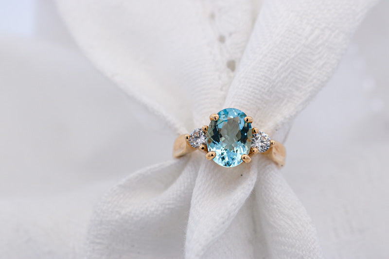 Blue Aquamarine and Diamond Ring Set in yellow gold on white material | McLean & Co Jewellers Sunshine Coast