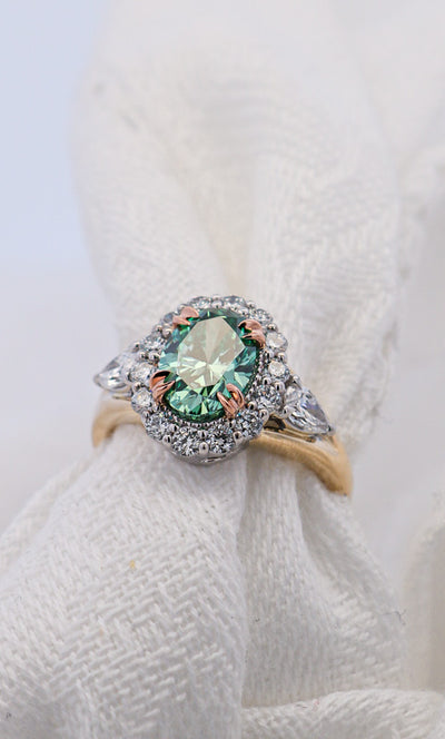 Fancy Style Green Diamond Ring Oval Shape Set with white diamonds in Yellow White and Rose Gold | McLean & Co Jewellers