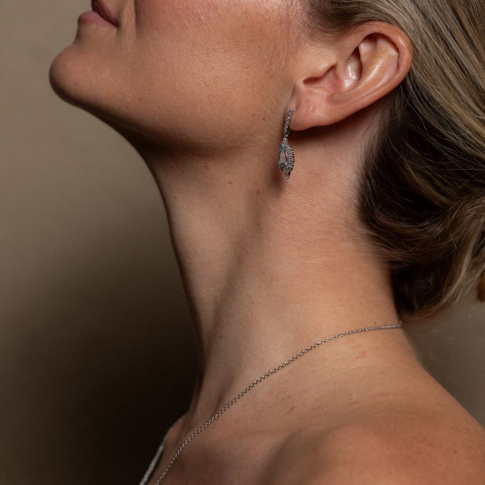 aquamarine diamond earrings drop  placed on girls ear mclean & co Australia