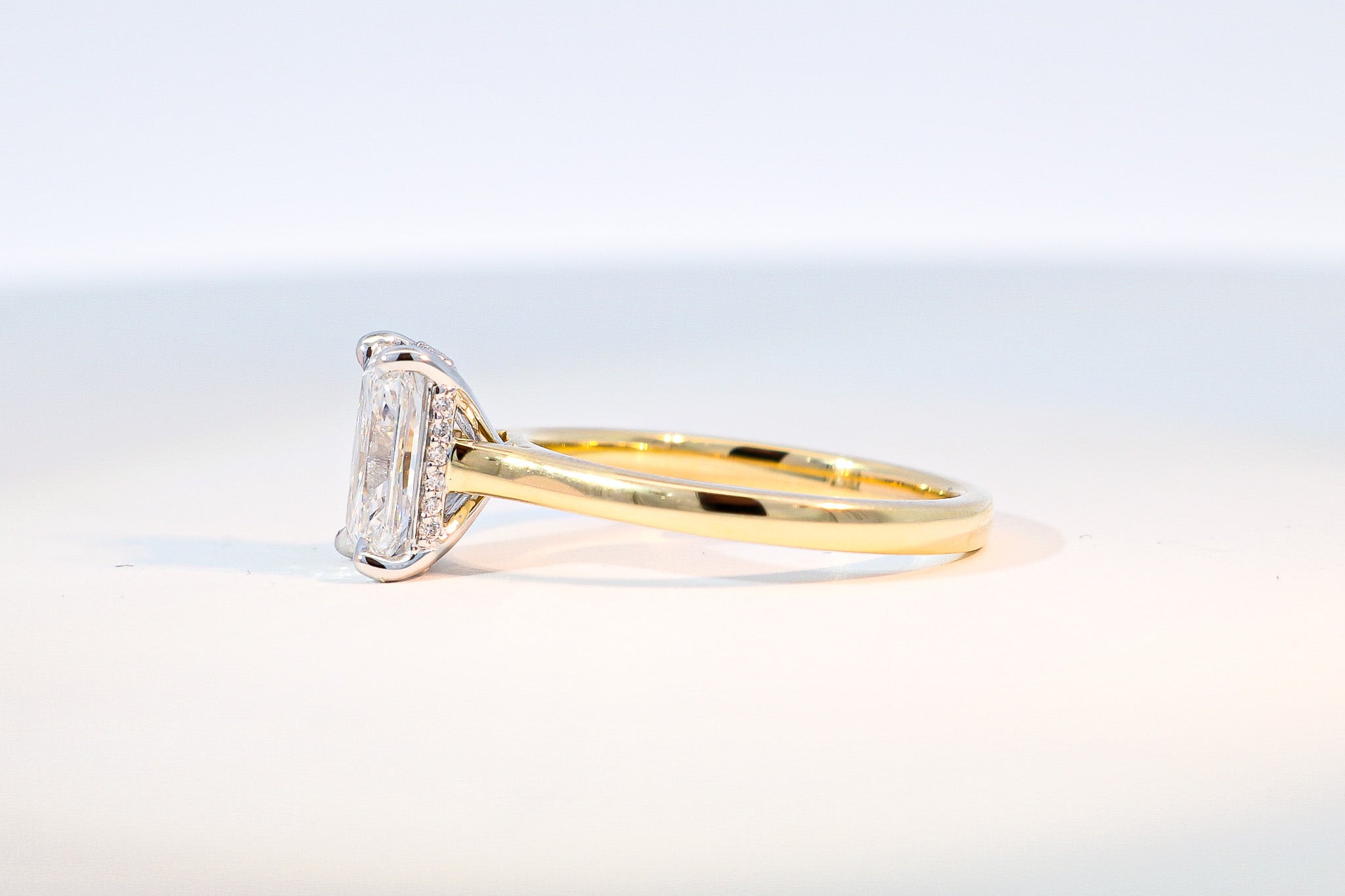 hidden halo diamond radiant cut engagement ring yellow gold band
