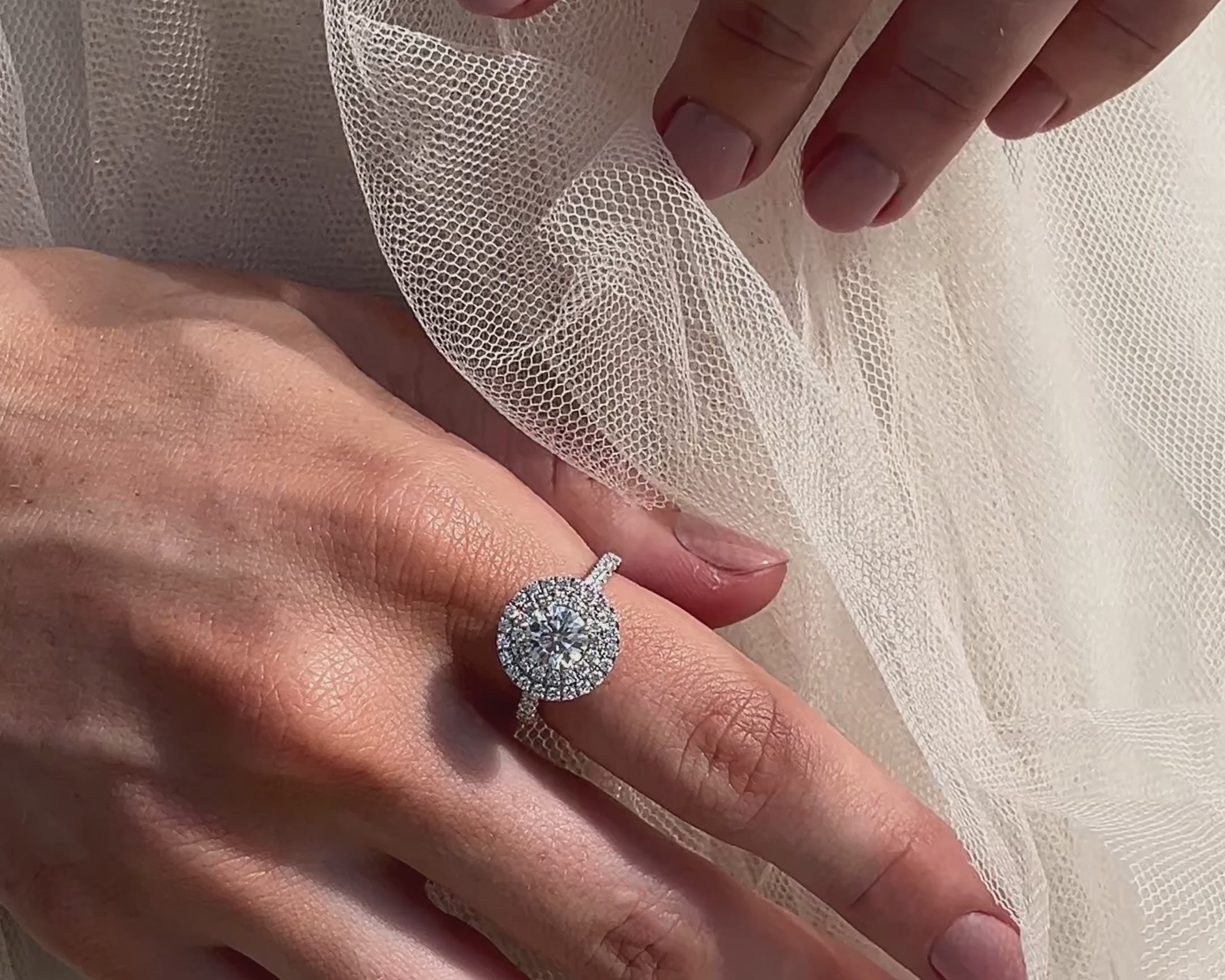 Double Halo Diamond Engagement Ring on hand with wedding dress 