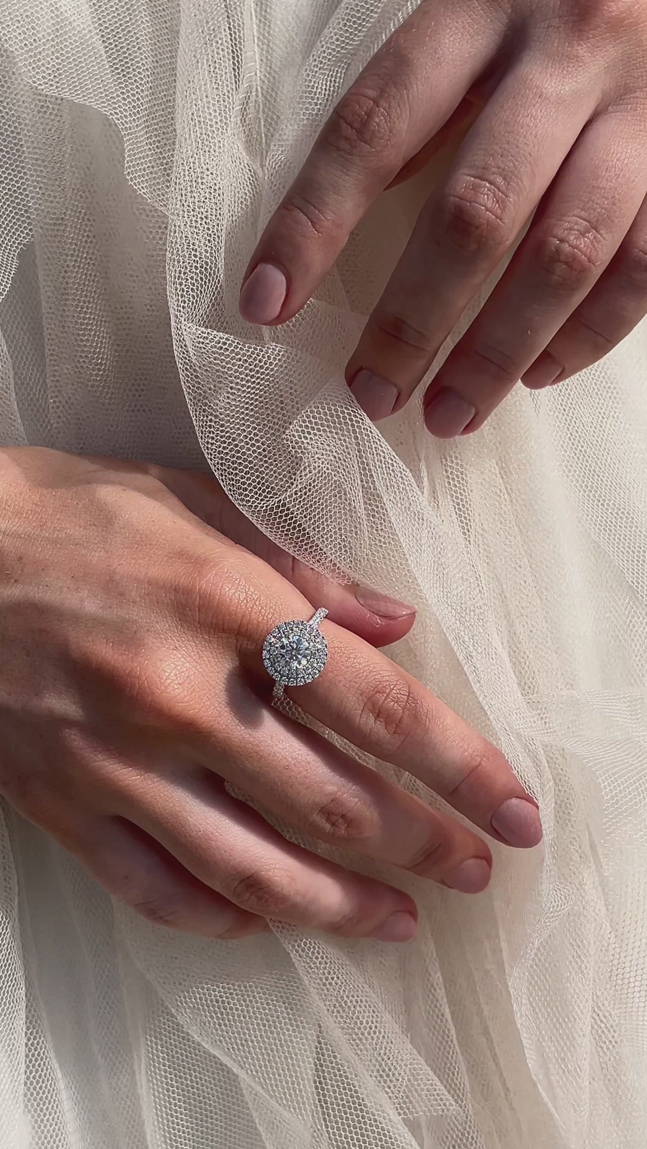 Double Halo Diamond Engagement Ring on hand with wedding dress 