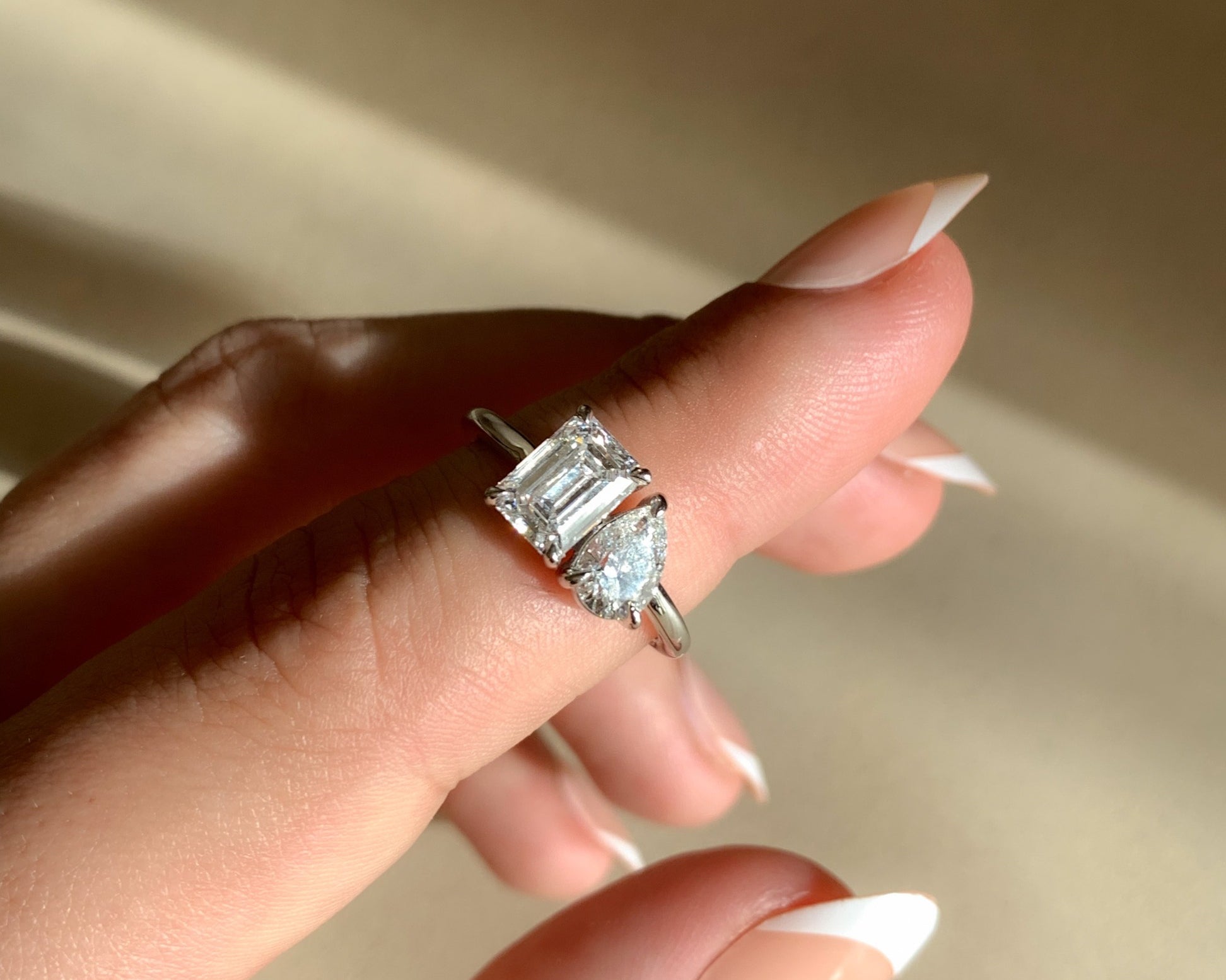 toi et moi engagement ring on hand