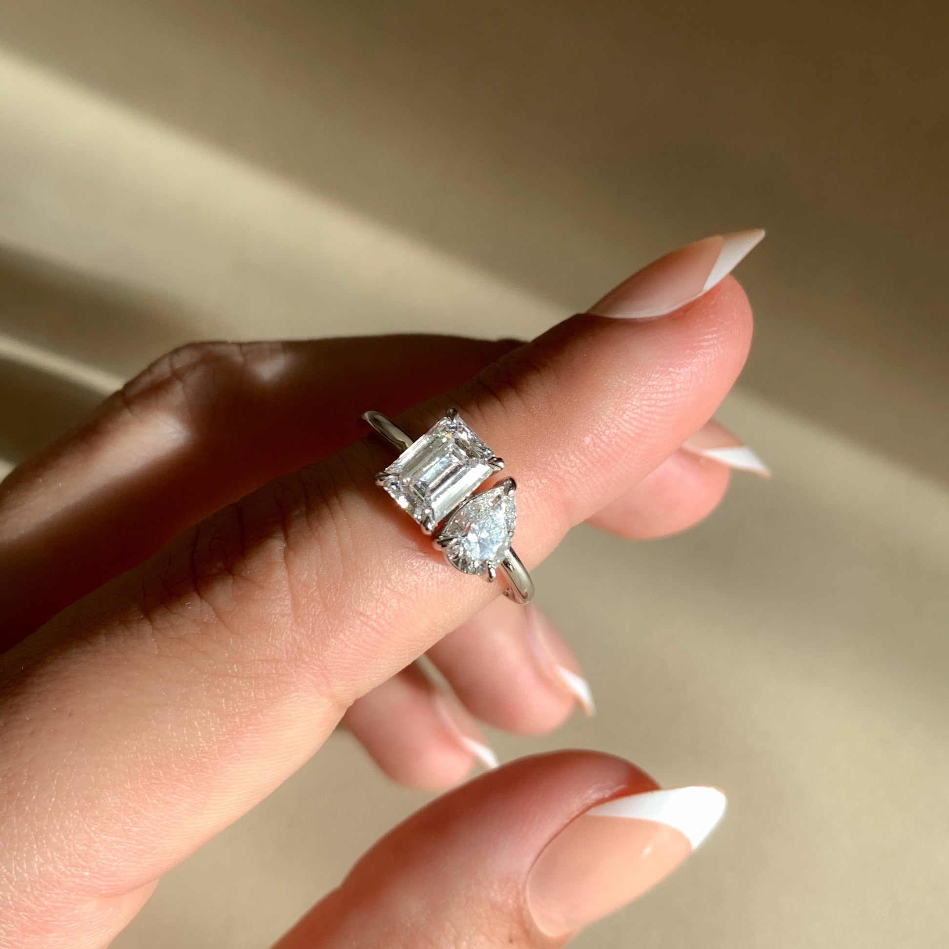 toi et moi engagement ring on hand